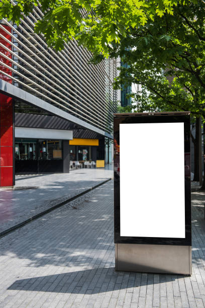 istock Vertical billboard with advertising space and copy space on white display screen photographed outdoors 693439796
