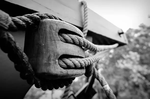 Black and white photo of block and tackle on a ship