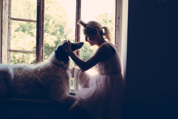 istock Blonde woman having fun with her dog 693449172