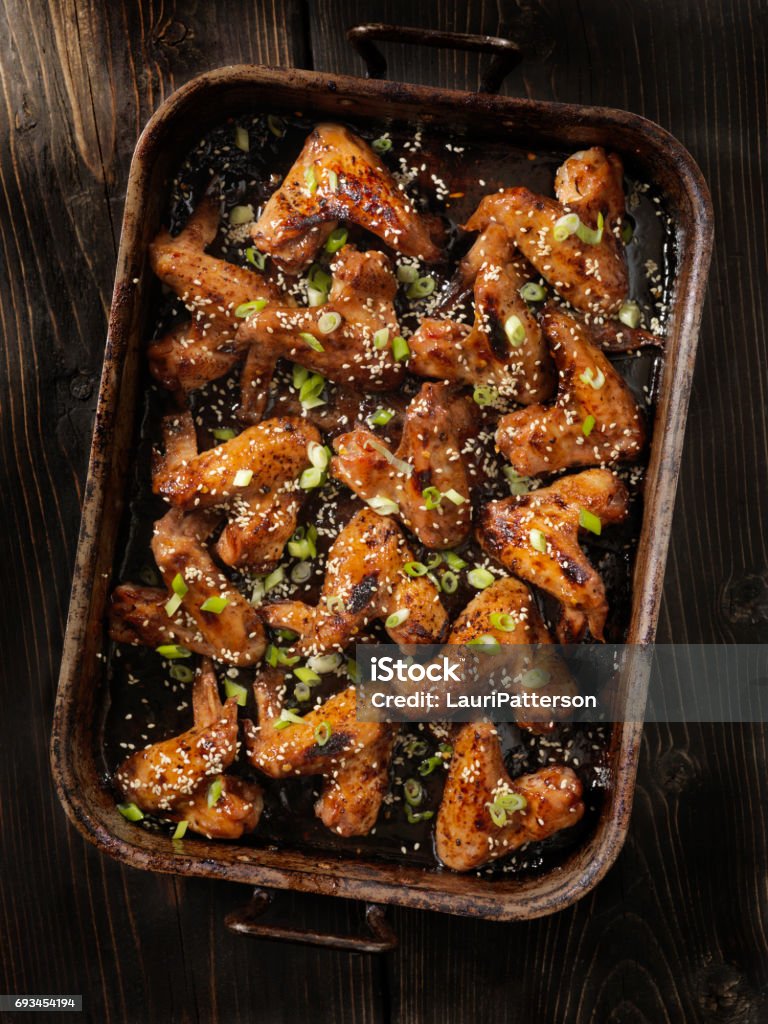 Baked Teriyaki Whole Chicken Wings Baked Teriyaki Whole Chicken Wings with Green Onion and Toasted Sesame Seeds Chicken Wing Stock Photo