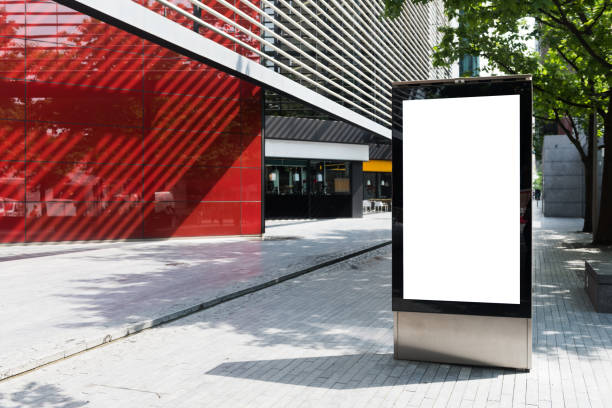 Vertical billboard with advertising space and copy space on white display screen photographed outdoors stock photo