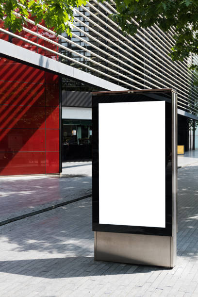 istock Vertical billboard with advertising space and copy space on white display screen photographed outdoors 693455076