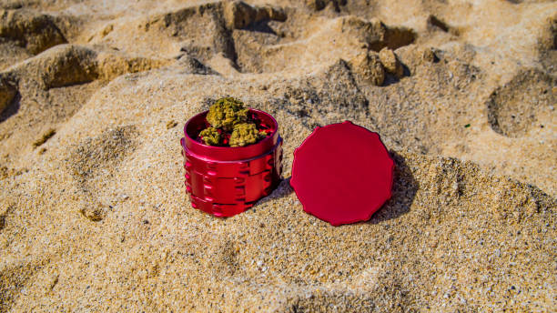 red cannabis grinder with cannabis