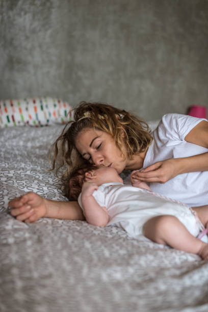 istock Mother kissing her baby 693468392
