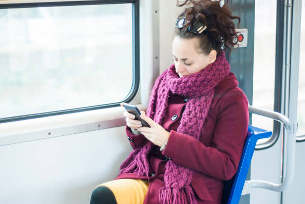 istock Woman travelling in public transport and using her phone 693471714