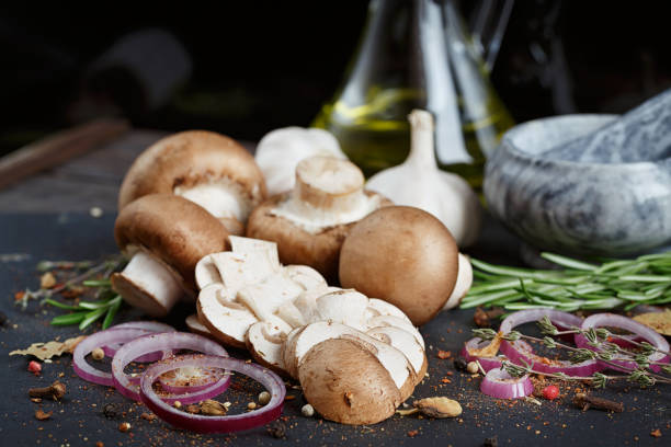 istock Button mushroom with rosemary, onion and peppercorns. Still life 693474962
