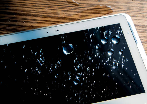 istock Drops of water on tablet screen 693501470