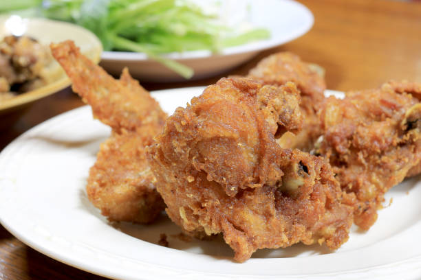 istock Spicy Deep Fried Breaded Chicken Wings in white dish on the table for dinner. 693519802
