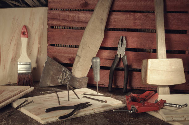 istock Retro stylized old tools on wooden table in a joinery. 693522574