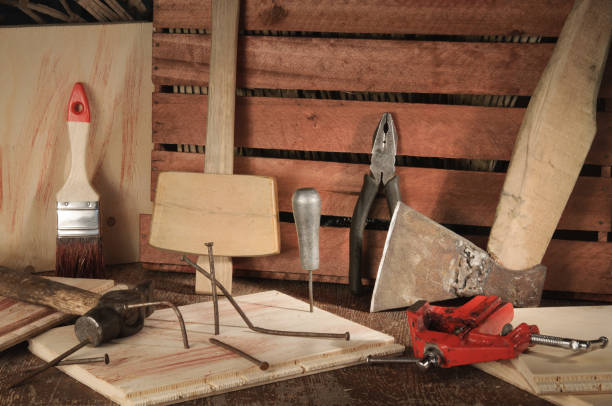 istock Retro stylized old tools on wooden table in a joinery. 693522576