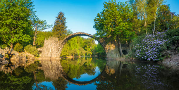 istock Devil's bridge in the park Kromlau, Germany,Flowering rhododendrons 693532450