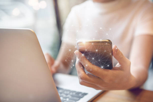 istock Woman hand using mobile phone and laptop, Worldwide connection technology interface. 693534976