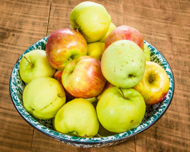 istock Bowl of organic apples on table 693537988