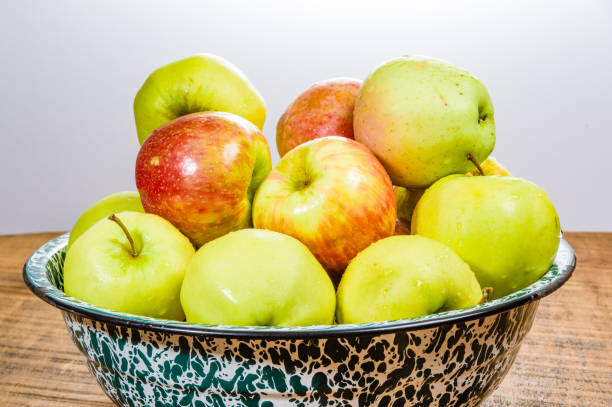 istock Bowl of organic apples on table 693538144