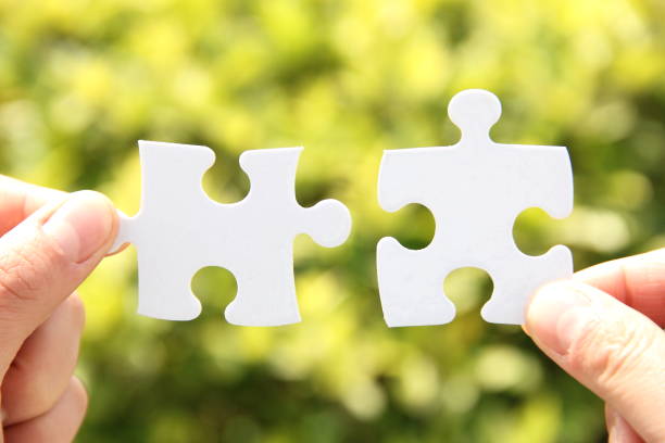 istock Female hand connecting jigsaw puzzle 693540558
