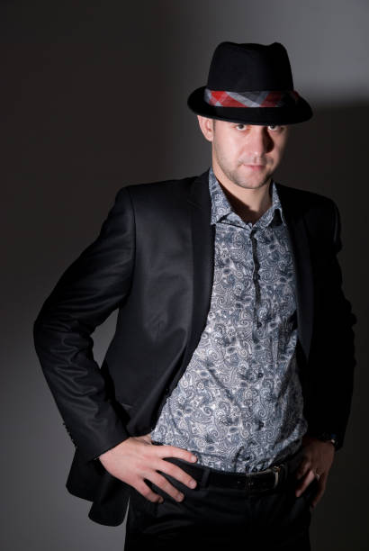 istock Young man portrait with hat on black background 693548140