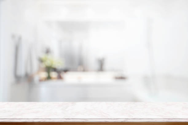 istock Empty pink marble top table for product display montage with blurred bathroom interior Bckground. 693553242