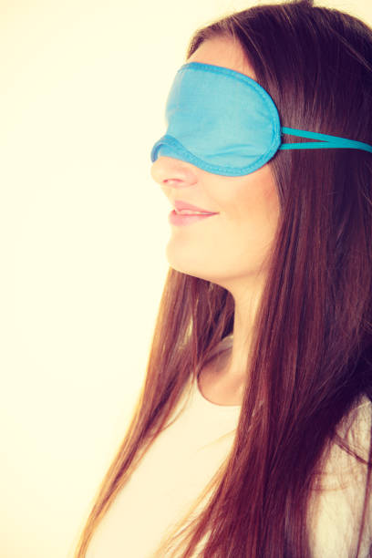 istock Brunette woman sleeping in blue eye sleep mask 693554006