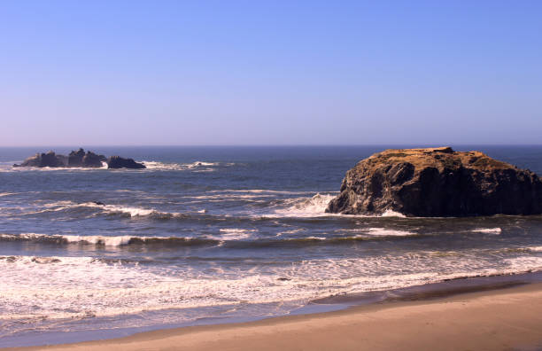istock Angry ocean waves against  a large rock 693554058