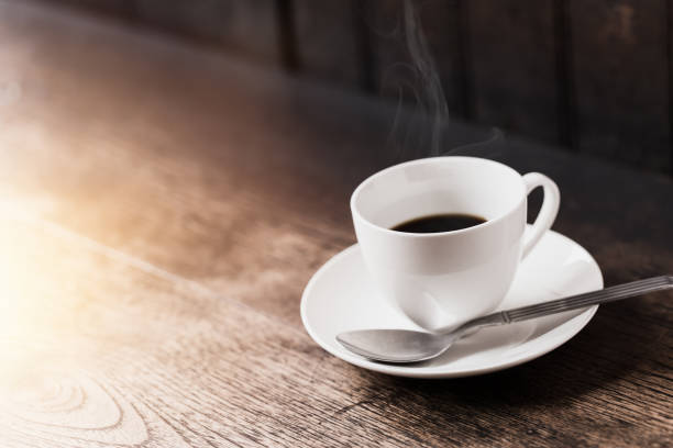 istock Espresso Coffee or Americano black Coffee in White cup on wood table with copy space. 693554878
