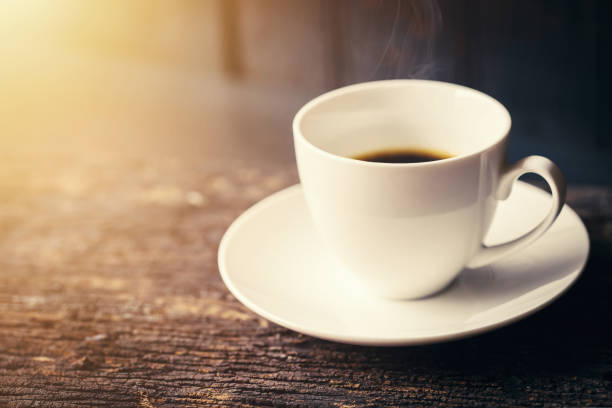 istock Espresso Coffee or Americano black Coffee in White cup on wood table with copy space. 693554920