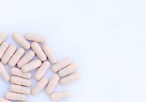 istock medical capsules on white background with copy space. 693557330