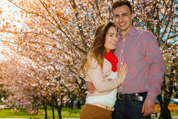 istock Happy couple having romantic date in park 693557660