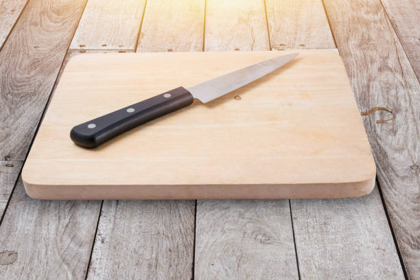 istock wood chop board or cutting board with kitchen knife on wood floor. 693557802
