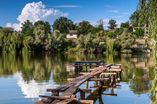 istock Rural landscape with small river and wooden bridge 693560752
