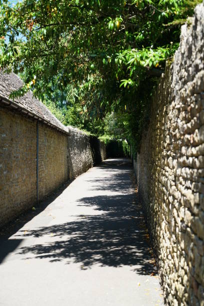 istock Honey-colored stone wall at Bourton on the water 693563680