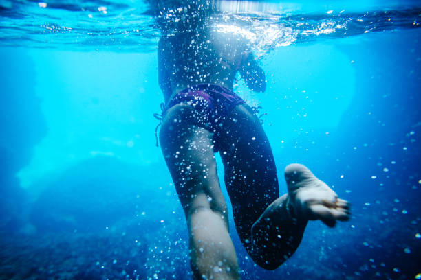 istock sexy woman swim underwater 693567536