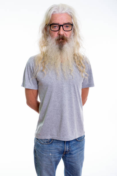 istock Studio shot of senior bearded man standing while wearing eyeglasses 693570348