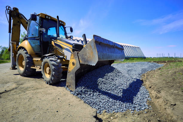 istock Laying rubble on the road with a heavy excavator. 693572666