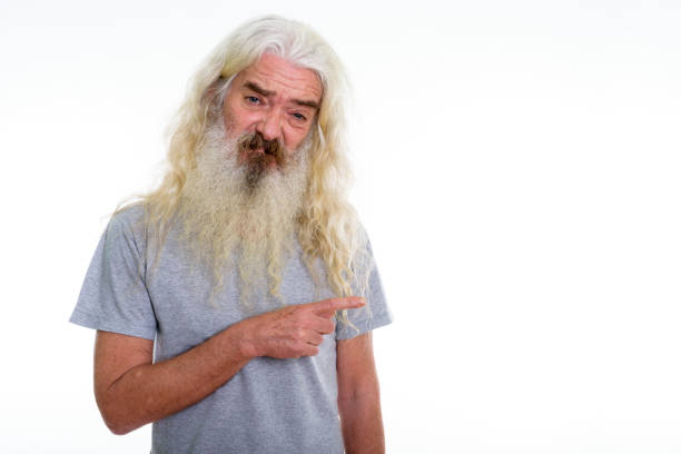 istock Studio shot of senior bearded man looking disgusted while pointing to the side 693573574