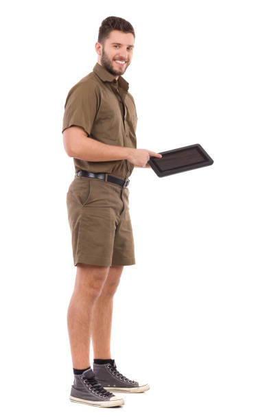 istock Messenger In Khaki Uniform Is Holding And Pointing At Digital Tablet 693573648