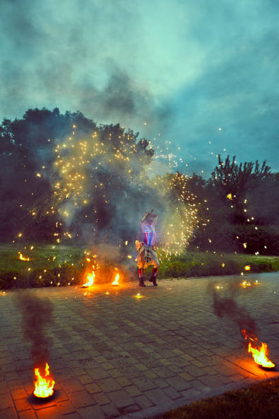 istock Dancing with fire in the dark on the street. 693573652