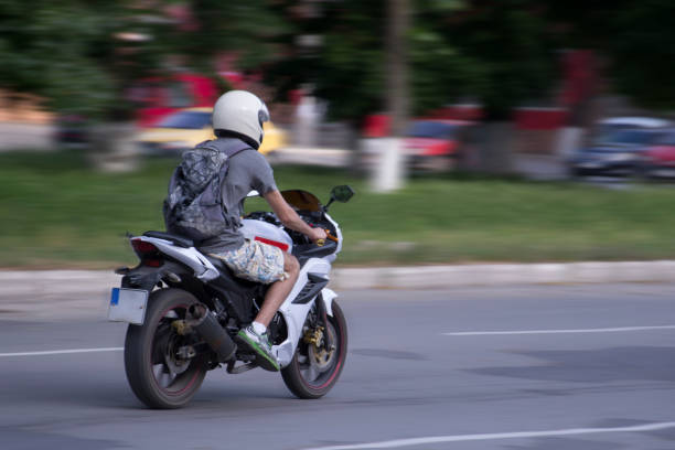 istock Concept. The motorcyclist is on the move. Abstract, blurry, bokeh background 693575960