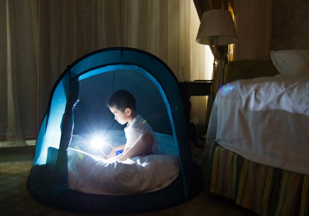 Young asian boy playing in tent.