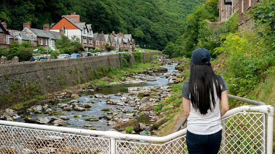 girl looking up the valley of the East Lyn River,   in Lynmouth in North Devon England UK