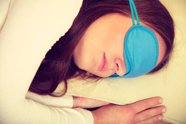 istock Brunette woman sleeping in blue eye sleep mask 693576766
