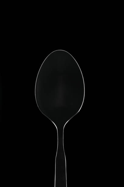 istock White contour spoon on black background 693579624