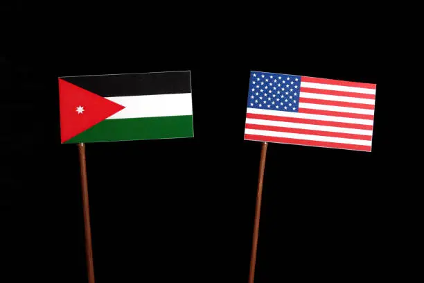 Jordanian flag with USA flag isolated on black background