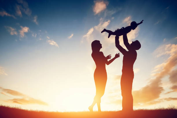 happy family together, parents with their little child at sunset. - new childbirth new life love imagens e fotografias de stock