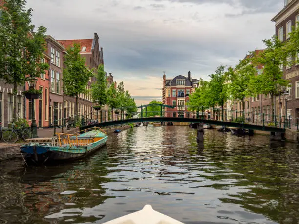 Shot from the water, view on the Old Rijn, Leiden, the Netherlands canals with historical houses in the dutch city of Leiden. Birthplace of Rembrandt van Rijn.