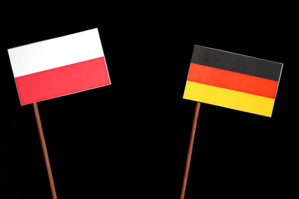 istock Polish flag with German flag isolated on black background 693594278