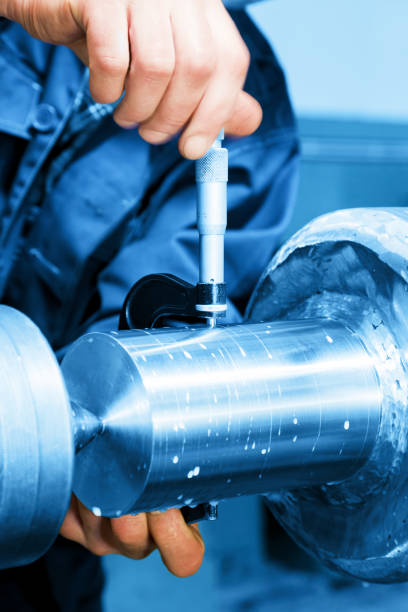 istock Worker measuring on industrial turning machine. Industry 693600082