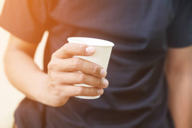 istock Man holding a paper coffee cup.Coffee lifestyle comcept. 693600696
