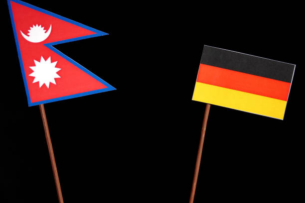 istock Nepal flag with German flag isolated on black background 693605748