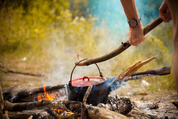 istock Camping kitchenware - pot on the fire at an outdoor campsite. 693610472