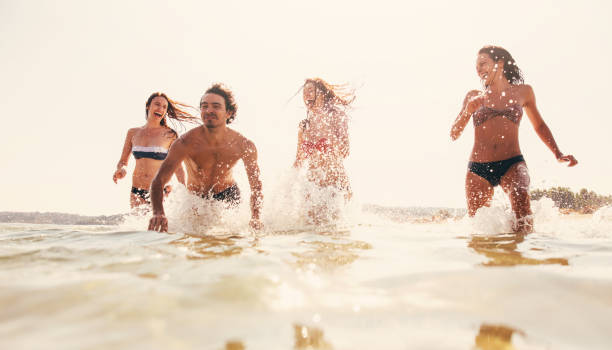 istock Friends having fun in the sea 693610666